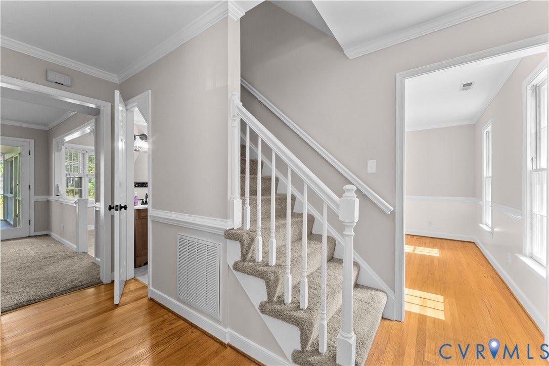2307 Garrison Place Terrace, Garrison Place, Midlothian, VA 23112 Staircase featuring a white balustrade with a wooden handrail, carpeted treads, wood-finish flooring, chair rail molding, and crown molding