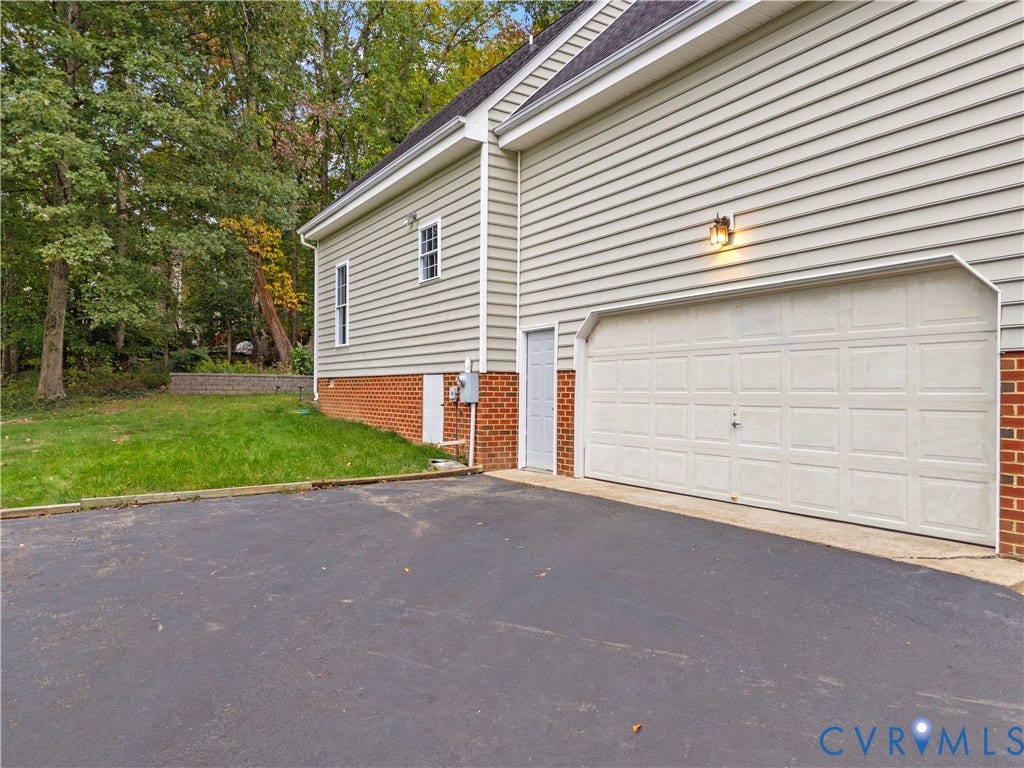 3437 Riverton Court, Robious Road Corridor, Midlothian, VA 23113 Exterior side profile featuring horizontal siding, brick veneer foundation, asphalt driveway, single-car garage door, and dedicated pedestrian entry door