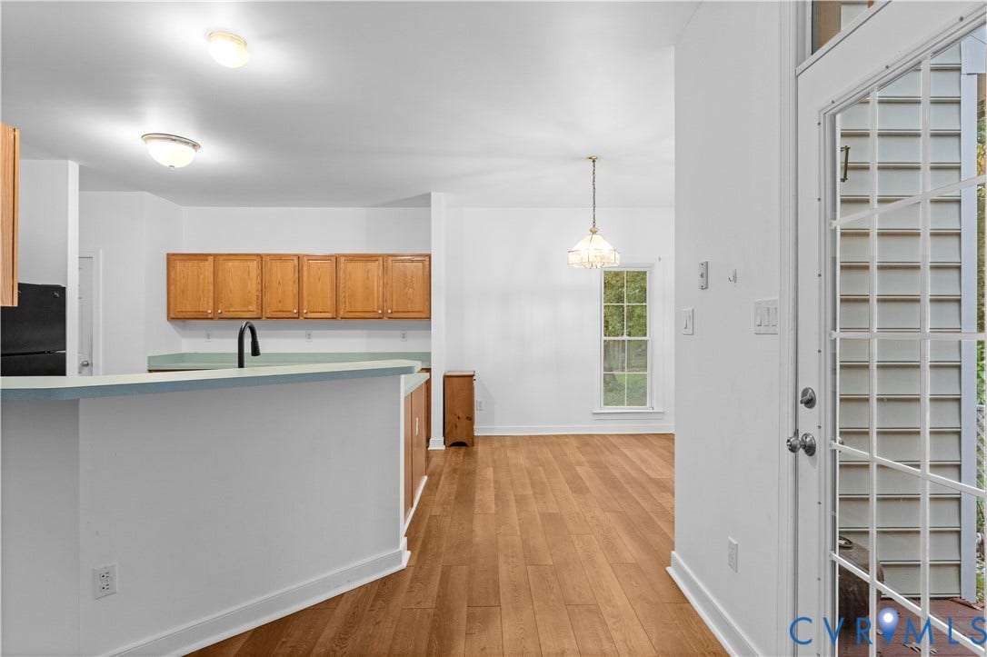 3437 Riverton Court, Robious Road Corridor, Midlothian, VA 23113 Kitchen area featuring wood-finish flooring, wood cabinetry, a peninsula with a solid-surface countertop, and a glass-paneled exterior door