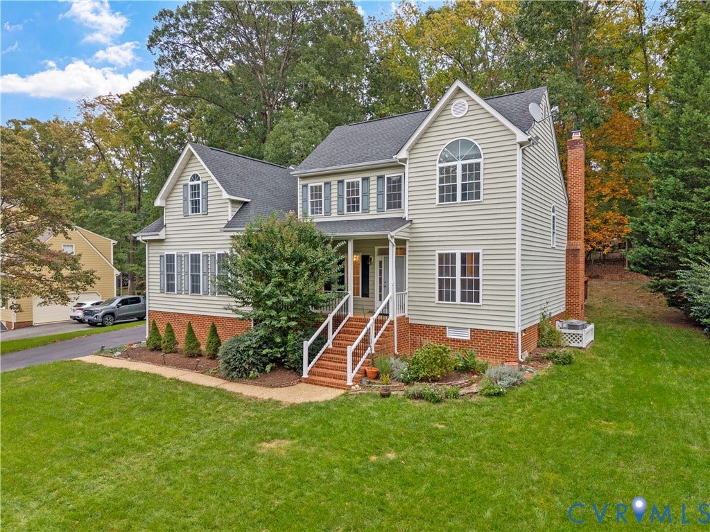 3437 Riverton Court, Robious Road Corridor, Midlothian, VA 23113 Two-story residence featuring light-colored horizontal siding, a prominent brick foundation, an exterior red-brick chimney, a covered front entry with steps, and multi-pane windows