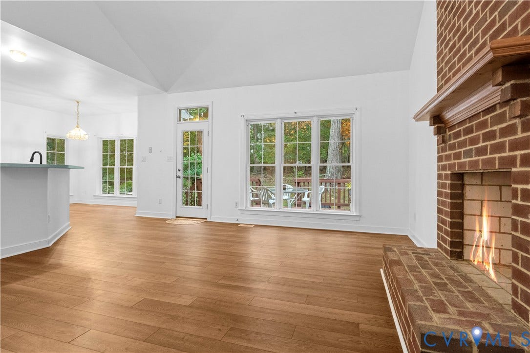 3437 Riverton Court, Robious Road Corridor, Midlothian, VA 23113 Vaulted ceilings, wood-finish flooring, floor-to-ceiling brick fireplace with a wood mantel, and large windows with pane detailing