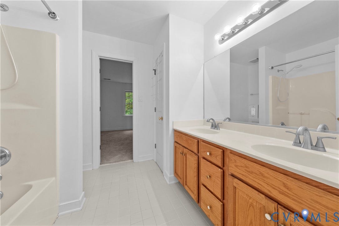 3437 Riverton Court, Robious Road Corridor, Midlothian, VA 23113 Bathroom featuring dual vanity with wood-finish cabinetry, solid surface countertop, integrated dual sinks, and large wall-mounted mirror