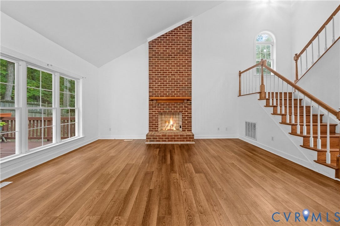 3437 Riverton Court, Robious Road Corridor, Midlothian, VA 23113 Vaulted ceilings, floor-to-ceiling brick fireplace with a wood mantel, wood-finish flooring, staircase with a wood handrail, and oversized windows