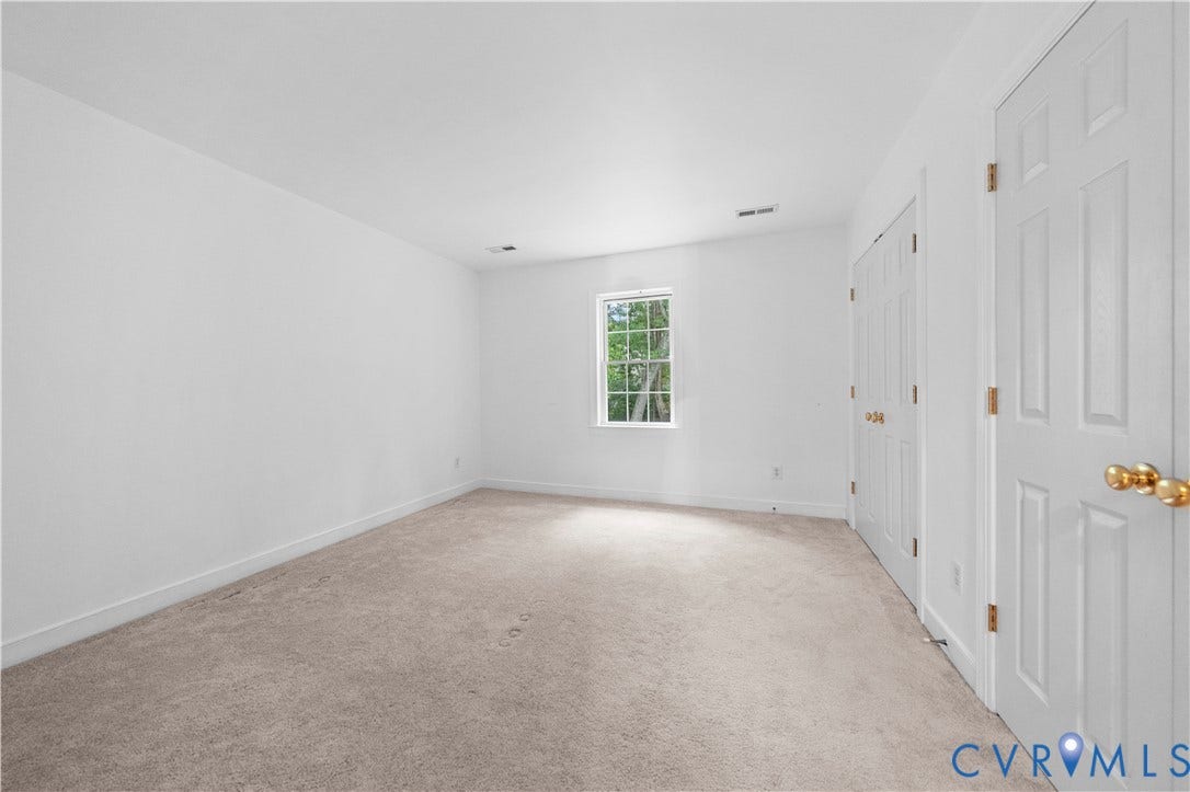 3437 Riverton Court, Robious Road Corridor, Midlothian, VA 23113 Neutral interior featuring neutral wall-to-wall carpeting, white walls, a single-pane window, and two sets of six-panel interior doors with metallic hardware