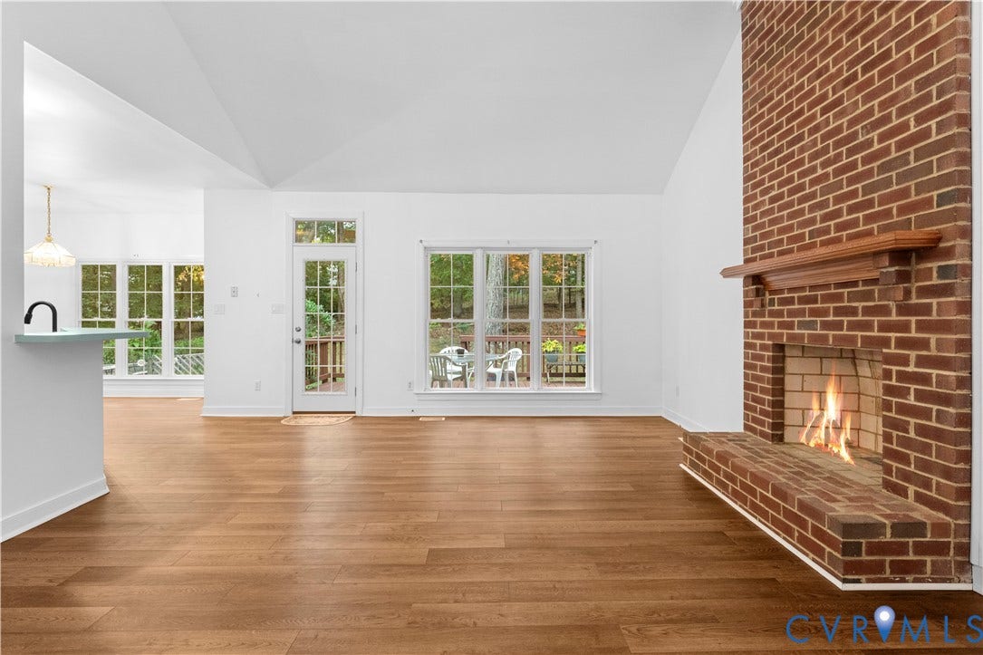 3437 Riverton Court, Robious Road Corridor, Midlothian, VA 23113 Vaulted ceilings, wood-finish flooring, floor-to-ceiling brick fireplace with a wood mantel, and multiple large windows