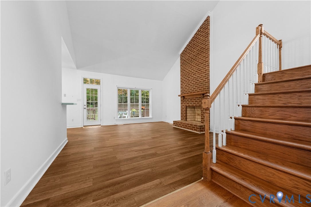 3437 Riverton Court, Robious Road Corridor, Midlothian, VA 23113 Vaulted ceiling, floor-to-ceiling brick fireplace with wood mantel, wood-finish flooring, and staircase with wooden handrails and balusters