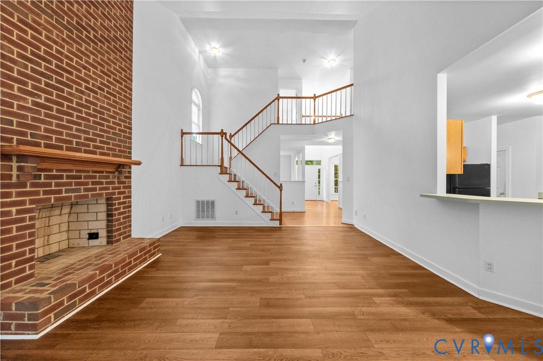 3437 Riverton Court, Robious Road Corridor, Midlothian, VA 23113 Floor-to-ceiling brick fireplace, wood-finish flooring, soaring vaulted ceilings, and a staircase with a wooden handrail and balusters