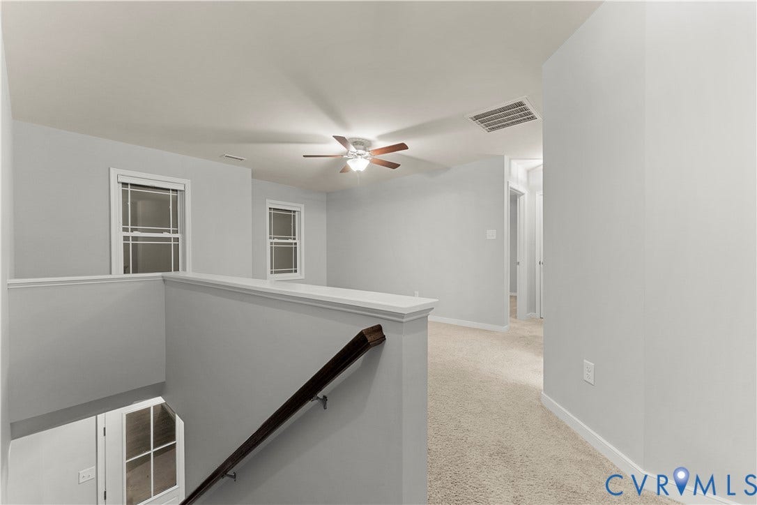 2953 Preston Park Court, Western Goochland County, Goochland, VA 23153 Recessed carpeted flooring, white interior walls, ceiling fan with integrated lighting, white trim, and a wood handrail