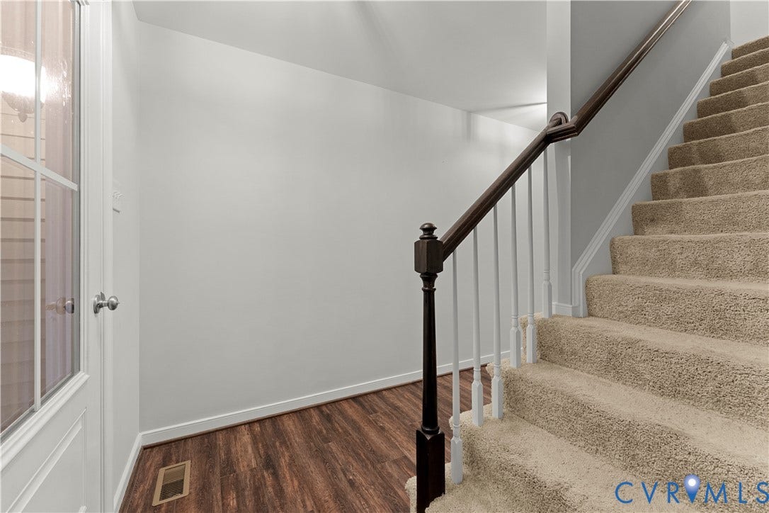 2953 Preston Park Court, Western Goochland County, Goochland, VA 23153 Carpeted staircase with dark wood-finish handrail, white balusters, and wood-finish flooring