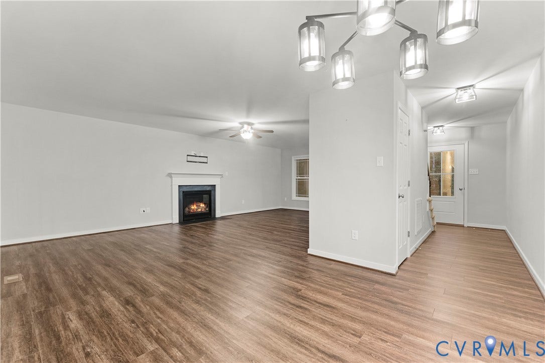 2953 Preston Park Court, Western Goochland County, Goochland, VA 23153 Spacious interior with wood-finish flooring, a fireplace with a mantel, and a ceiling fan