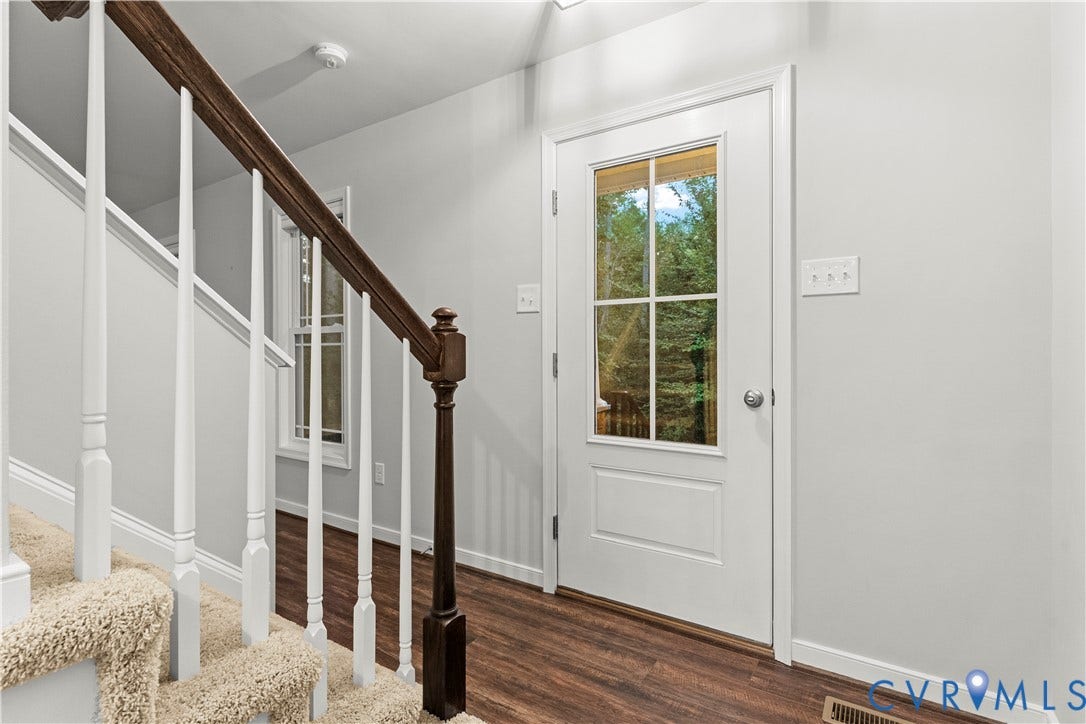 2953 Preston Park Court, Western Goochland County, Goochland, VA 23153 Wood-finish flooring throughout, carpeted staircase with wood banister, built-in light fixture, and sliding glass door with exterior deck