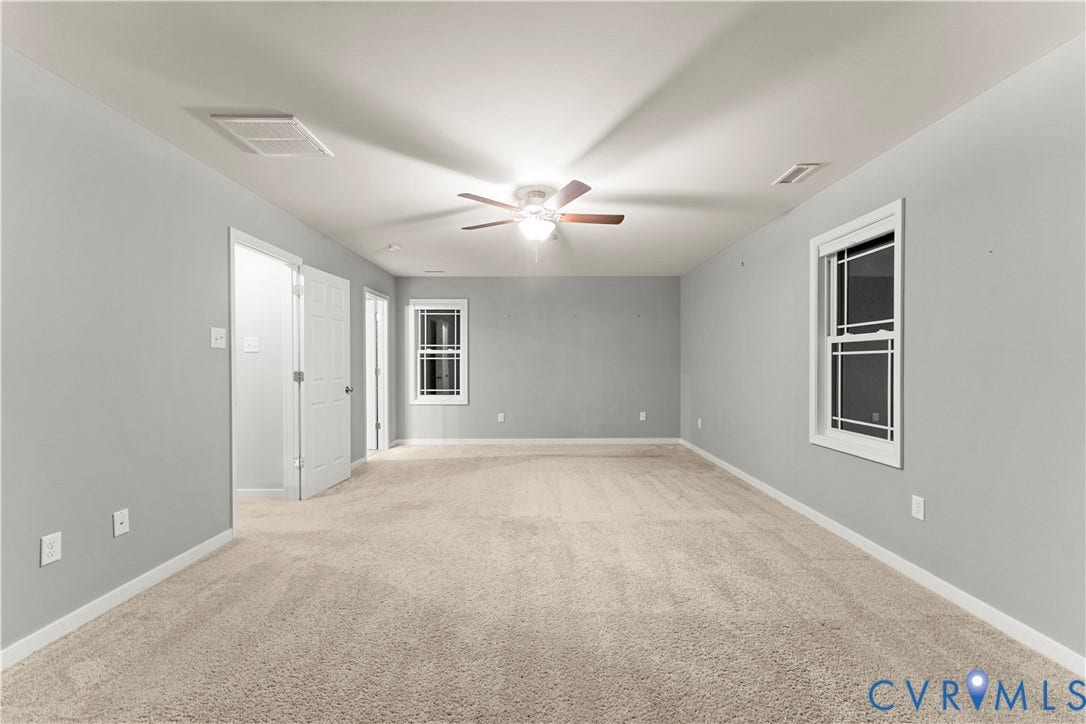 2953 Preston Park Court, Western Goochland County, Goochland, VA 23153 Carpeted flooring, light grey wall paint, two windows with white trim, white doors, and a ceiling fan with light fixture