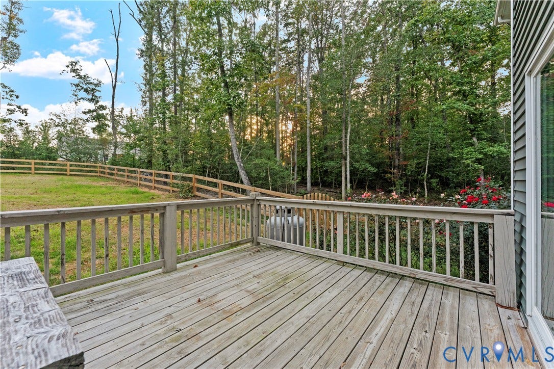 2953 Preston Park Court, Western Goochland County, Goochland, VA 23153 Expansive backyard featuring a wood fence, mature trees, wood deck, and a concrete patio