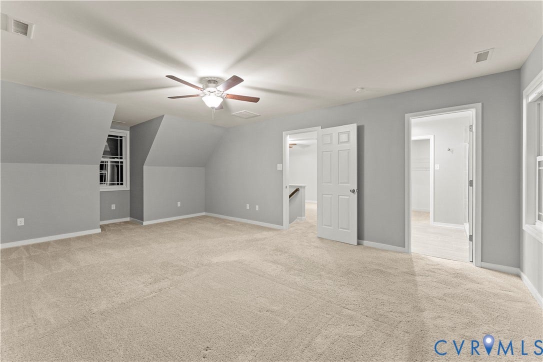 2953 Preston Park Court, Western Goochland County, Goochland, VA 23153 Spacious primary suite featuring neutral carpet flooring, ceiling fan with integrated lighting, abundant natural light from multiple windows, and direct access to ensuite bathroom