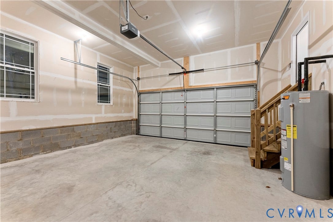 2953 Preston Park Court, Western Goochland County, Goochland, VA 23153 Concrete floor garage with a paneled garage door, two windows, and a built-in water heater