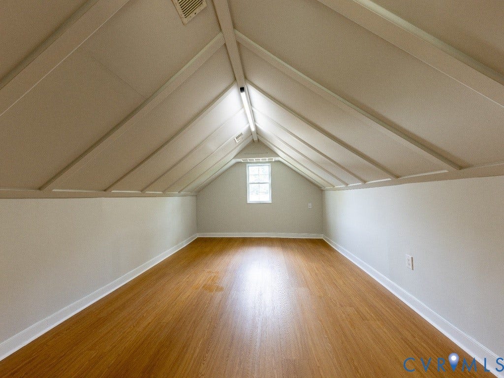 2201 Richmond Street, Hopewell, VA 23860 Pitched ceiling with exposed beams, wood-finish flooring, and a double-hung window