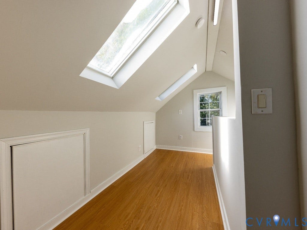 2201 Richmond Street, Hopewell, VA 23860 Wood-finish flooring with dual skylights, a single window, and two built-in storage access panels