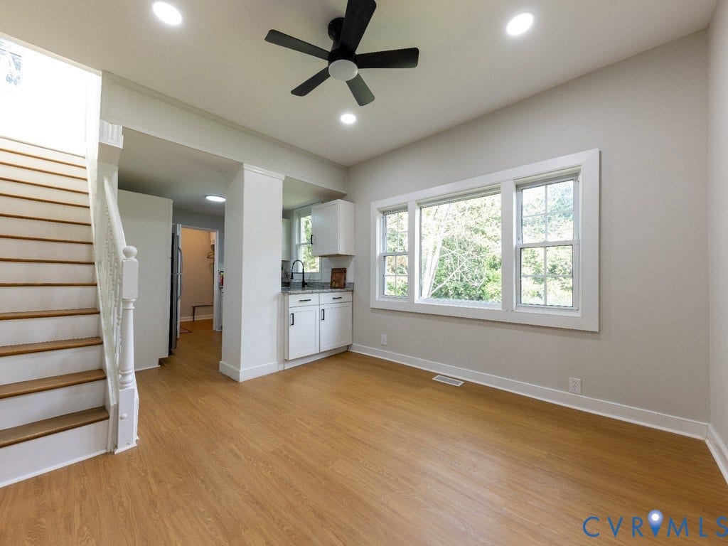 2201 Richmond Street, Hopewell, VA 23860 Wood-finish flooring, recessed lighting, white window trim, white cabinetry, and a black ceiling fan