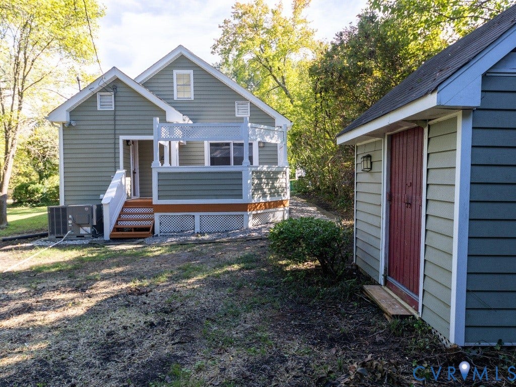 2201 Richmond Street, Hopewell, VA 23860 Rear exterior with a wood-finish deck, white railing, and lattice skirting