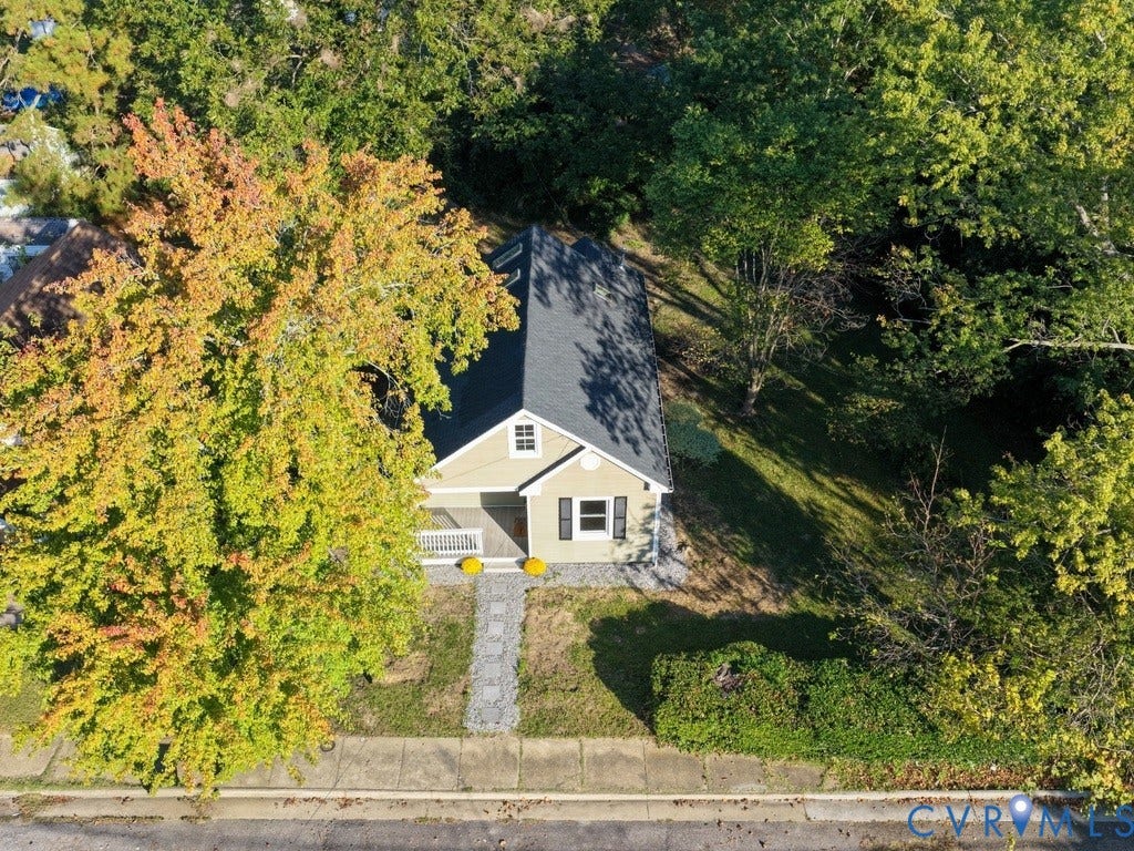 2201 Richmond Street, Hopewell, VA 23860 Gabled residence with a covered front porch, dark-toned roof, and a mature tree-lined property