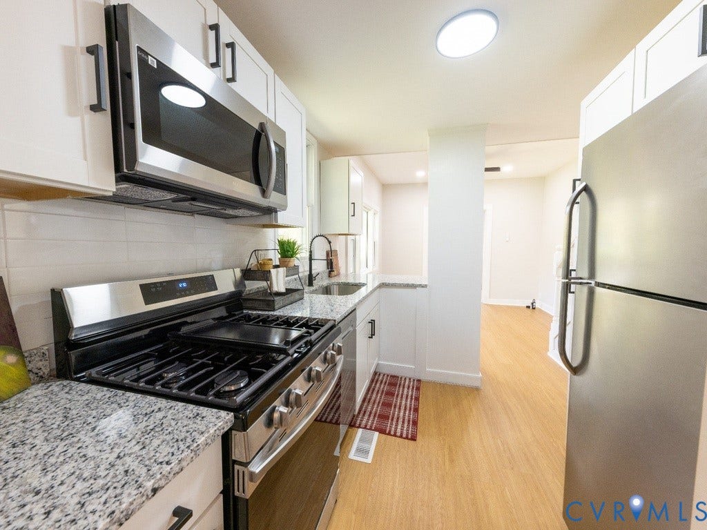2201 Richmond Street, Hopewell, VA 23860 Kitchen featuring stainless steel appliances, white cabinetry, a tile backsplash, and light-toned flooring