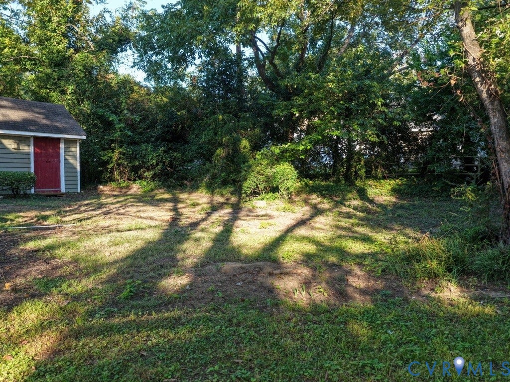 2201 Richmond Street, Hopewell, VA 23860 Rear yard featuring a storage shed with green siding and a red door