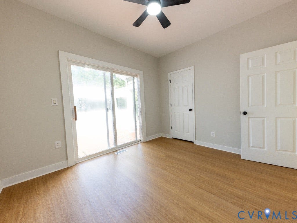 2201 Richmond Street, Hopewell, VA 23860 Wood-finish flooring, sliding glass door, overhead ceiling fan with lighting, and white paneled doors