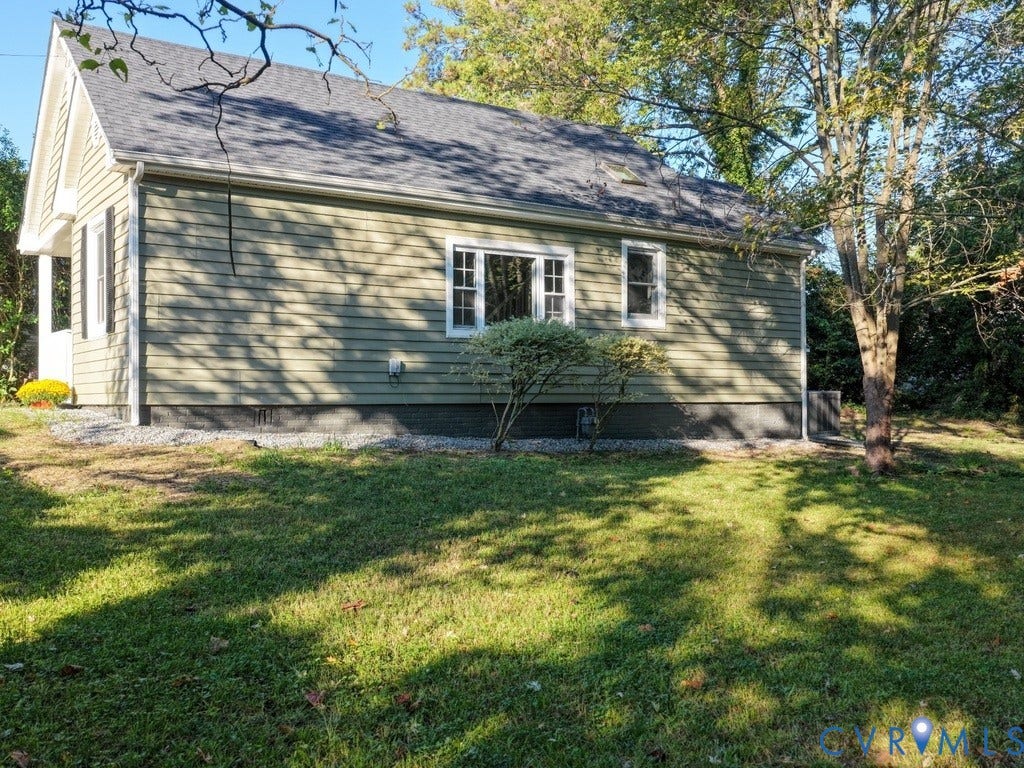 2201 Richmond Street, Hopewell, VA 23860 Green siding exterior with white trim, dark shingle roof, and a gravel perimeter