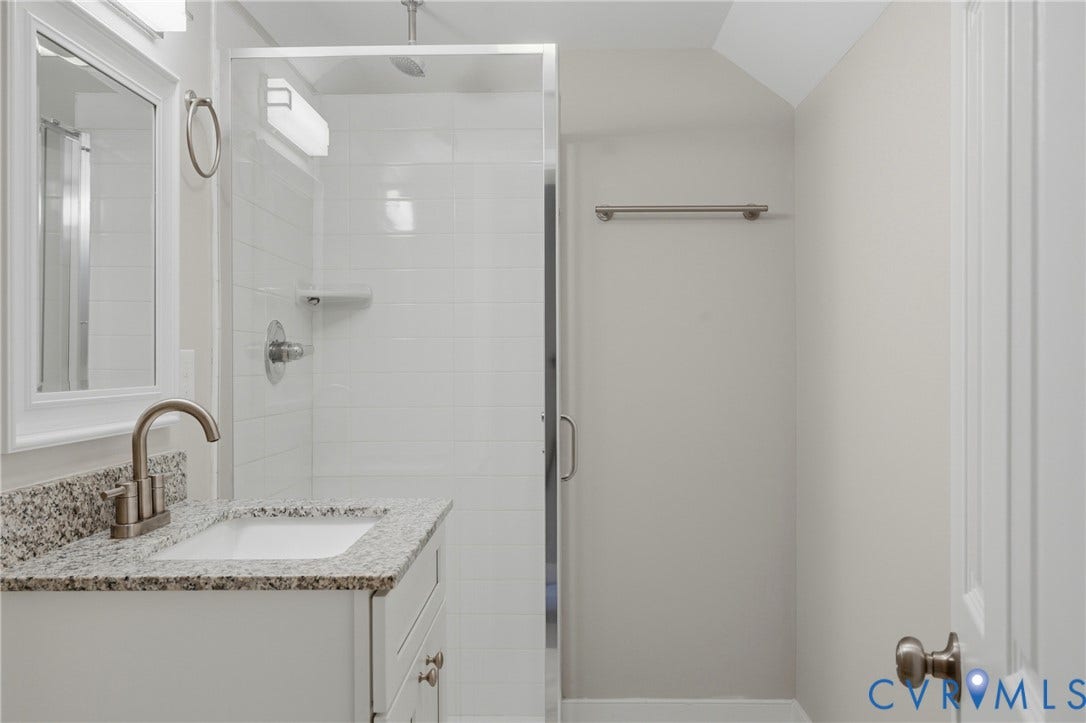 6624 Miller Road, Henrico, VA 23231 Upstairs Modern bathroom featuring a glass shower enclosure, speckled granite countertop with undermount sink, brushed nickel faucet and hardware, white cabinetry with soft-close drawers, and recessed ceiling lighting throughout