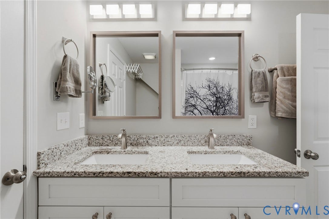6624 Miller Road, Henrico, VA 23231 Dual vanity with undermount sinks, speckled countertop, and individual framed mirrors