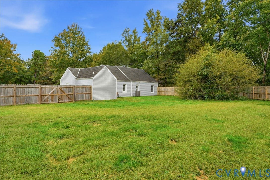 6624 Miller Road, Henrico, VA 23231 Charming home set on expansive grounds featuring manicured lawn, mature tree-lined perimeter, and wooden privacy fencing