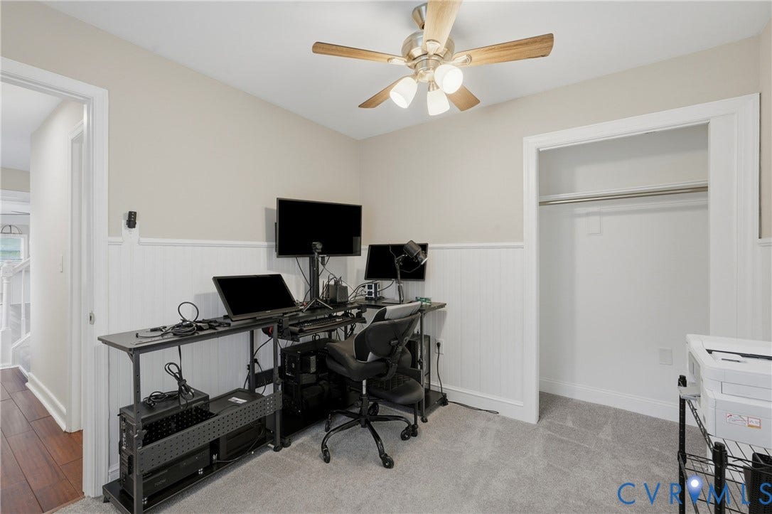 6624 Miller Road, Henrico, VA 23231 Recessed open closet with a hanging rod, wainscoting paneling, neutral wall paint, and a ceiling fan with integrated lighting