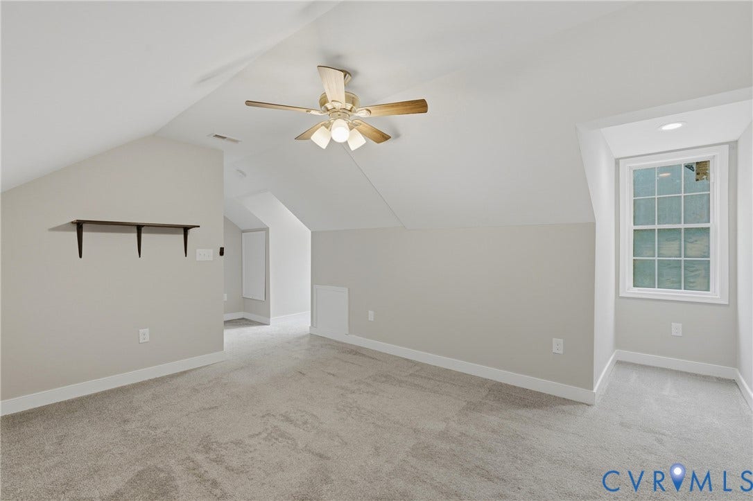 6624 Miller Road, Henrico, VA 23231 Bright upper-level bedroom with vaulted ceilings, ceiling fan with integrated lighting, dormer windows, and wall-to-wall carpeting