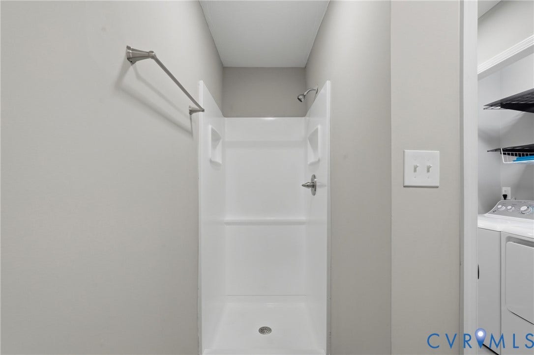 6624 Miller Road, Henrico, VA 23231 2nd full bath on 1st floor. Shower enclosure featuring a chrome shower head with wall-mounted arm, and a slip-resistant floor pan