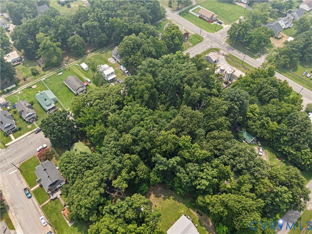 Expansive wooded acreage with surrounding residential properties and street access