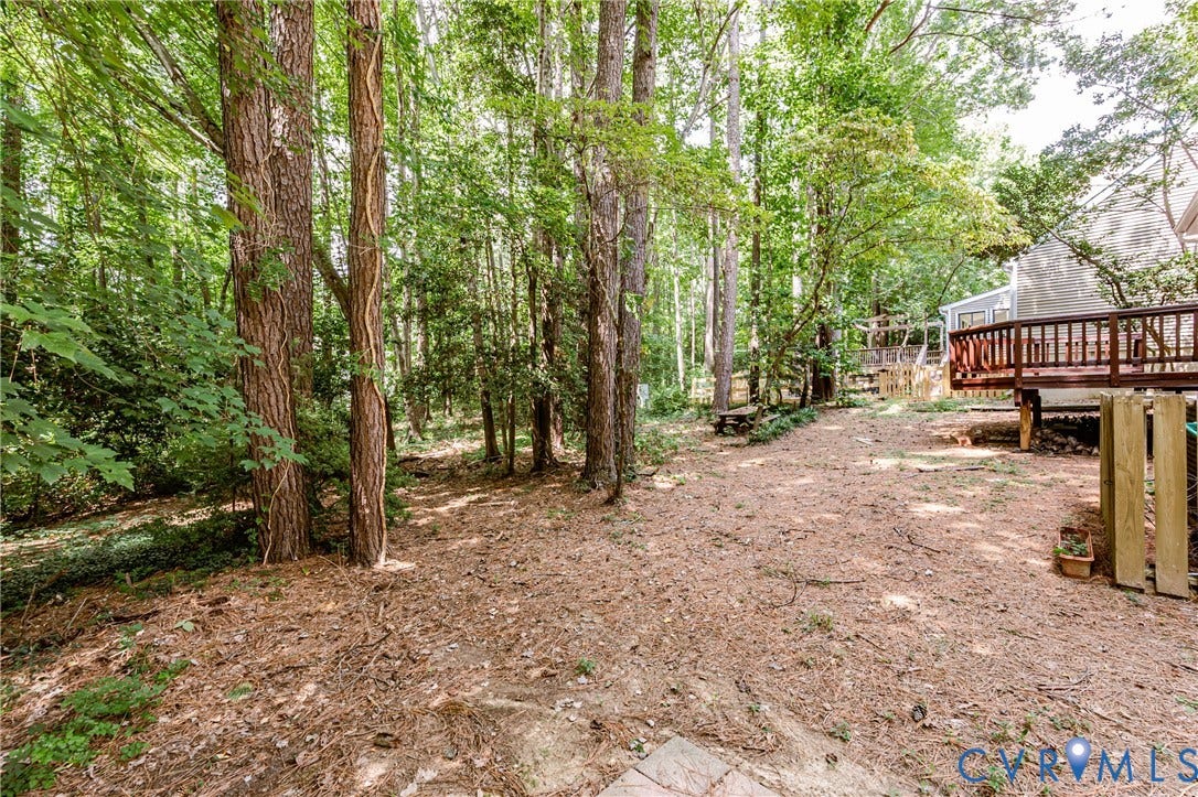 Wooded outdoor space with a raised wooden deck