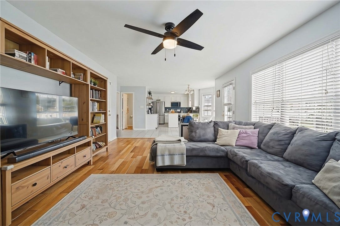 3912 Houze Terrace, Spring Lake, Henrico, VA 23060 Bright upper-level hallway featuring gleaming wood-finish flooring, white six-panel closet doors with brushed brass hardware, and a wood stair railing with turned balusters