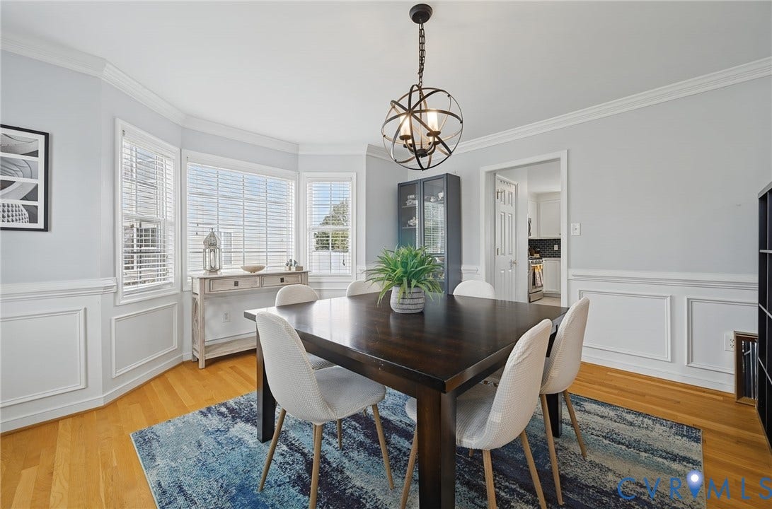 3912 Houze Terrace, Spring Lake, Henrico, VA 23060 Bright dining space with wood flooring, crown molding, wainscoting, and a bay window