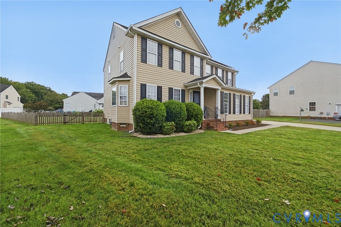 3912 Houze Terrace, Spring Lake, Henrico, VA 23060 Classic Colonial-style residence featuring a gabled roofline with architectural detail, cream-colored vinyl siding, and black shuttered windows
