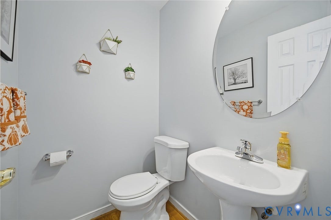 3912 Houze Terrace, Spring Lake, Henrico, VA 23060 Hardwood flooring, painted banister with white spindles, decorative wall niche with scallop detailing, white six-panel door, and recessed lighting