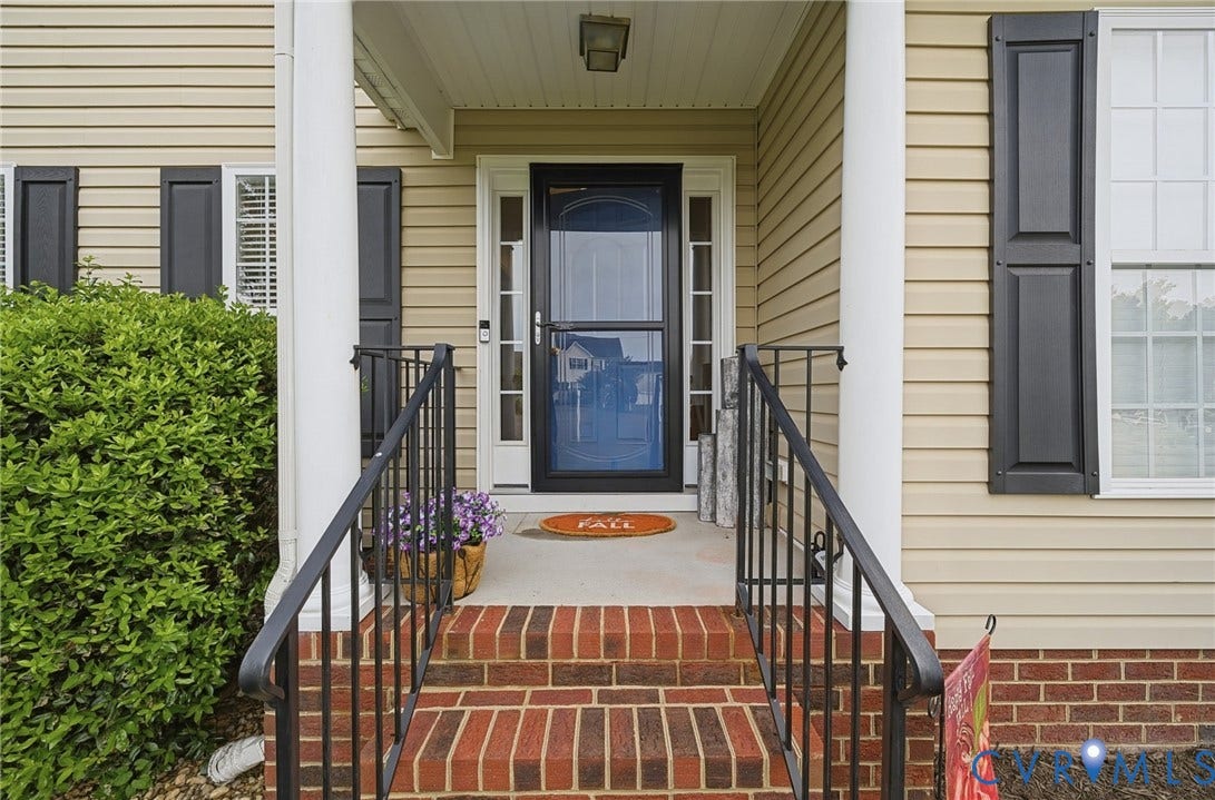 3912 Houze Terrace, Spring Lake, Henrico, VA 23060 Welcoming entry featuring a brick front staircase with black metal railings, navy blue entry door with sidelights, and a covered portico