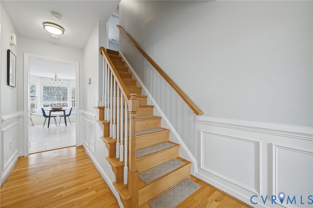 3912 Houze Terrace, Spring Lake, Henrico, VA 23060 Hardwood flooring, wainscoting, solid wood staircase with white balusters, recessed lighting, and a chandelier in the background