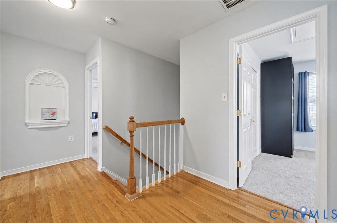3912 Houze Terrace, Spring Lake, Henrico, VA 23060 Spacious primary bedroom with neutral carpet flooring, ceiling fan with integrated lighting, wood-finish dresser, and multiple windows dressed with blue curtains providing natural light throughout the room