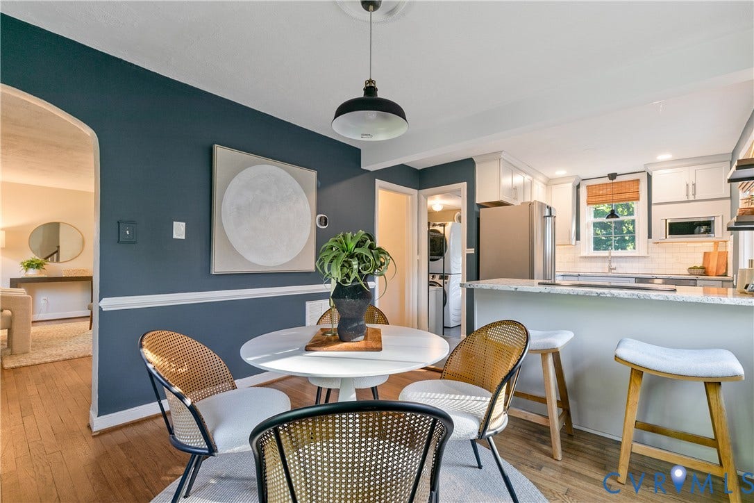 2207 Locbury Lane, Henrico, VA 23228 Dining area featuring wood-finish flooring, a pendant light fixture, and arched doorway entry