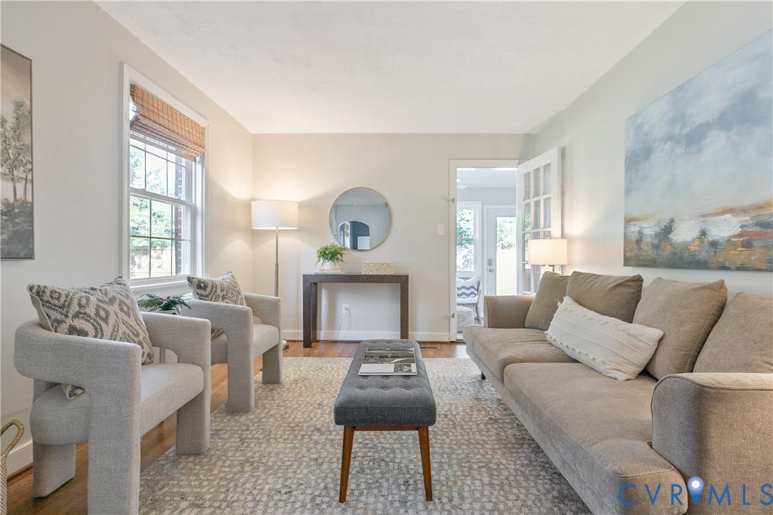 2207 Locbury Lane, Henrico, VA 23228 Living area featuring wood-finish flooring, a multi-pane glass door, and a single-hung window with a neutral frame