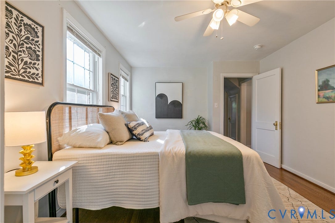 2207 Locbury Lane, Henrico, VA 23228 Bedroom interior featuring wood-finish flooring, two multi-pane windows, a central ceiling fan with integrated lighting, and a traditional four-panel interior door