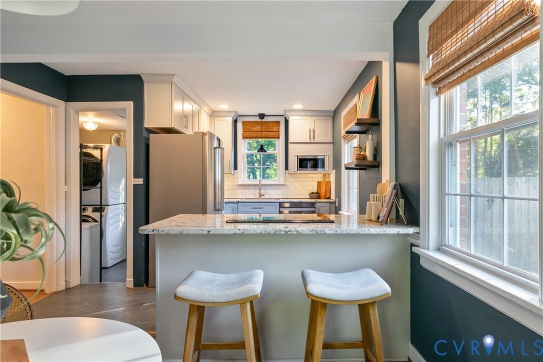 2207 Locbury Lane, Henrico, VA 23228 Kitchen featuring a stone-topped breakfast bar, stainless steel appliances, white cabinetry, subway tile backsplash, and built-in floating shelving