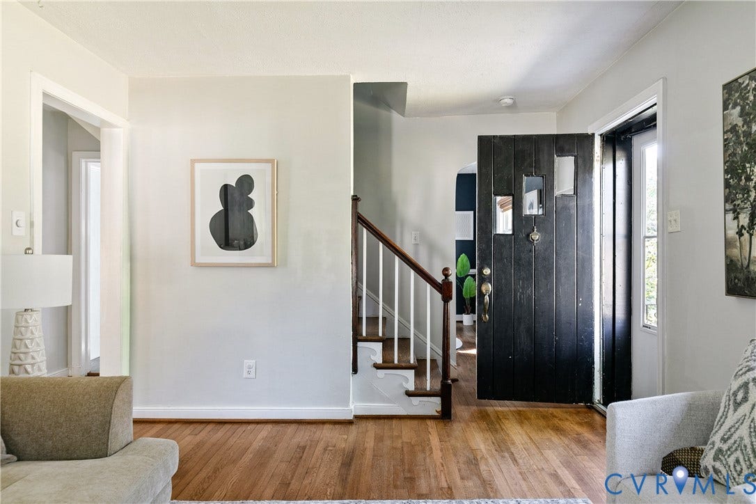 2207 Locbury Lane, Henrico, VA 23228 Entryway featuring wood-finish flooring, a black-painted front door with inset glass panels, and a staircase with white balusters and a wood handrail