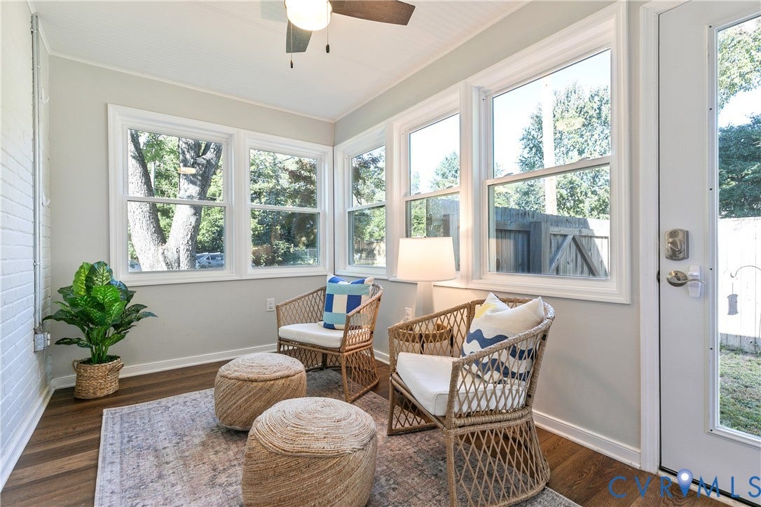 2207 Locbury Lane, Henrico, VA 23228 Sunroom featuring expansive windows, wood-finish flooring, painted brick accent wall, and ceiling fan