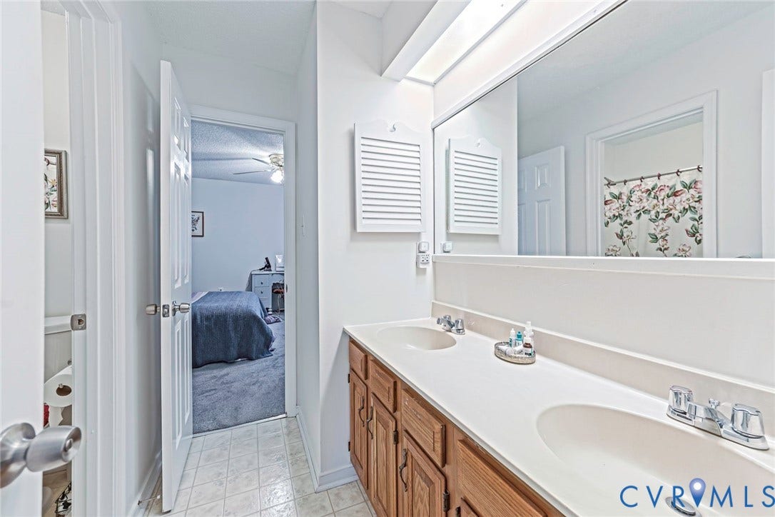 Dual-sink vanity with lots of storage and wall-to-wall mirror.